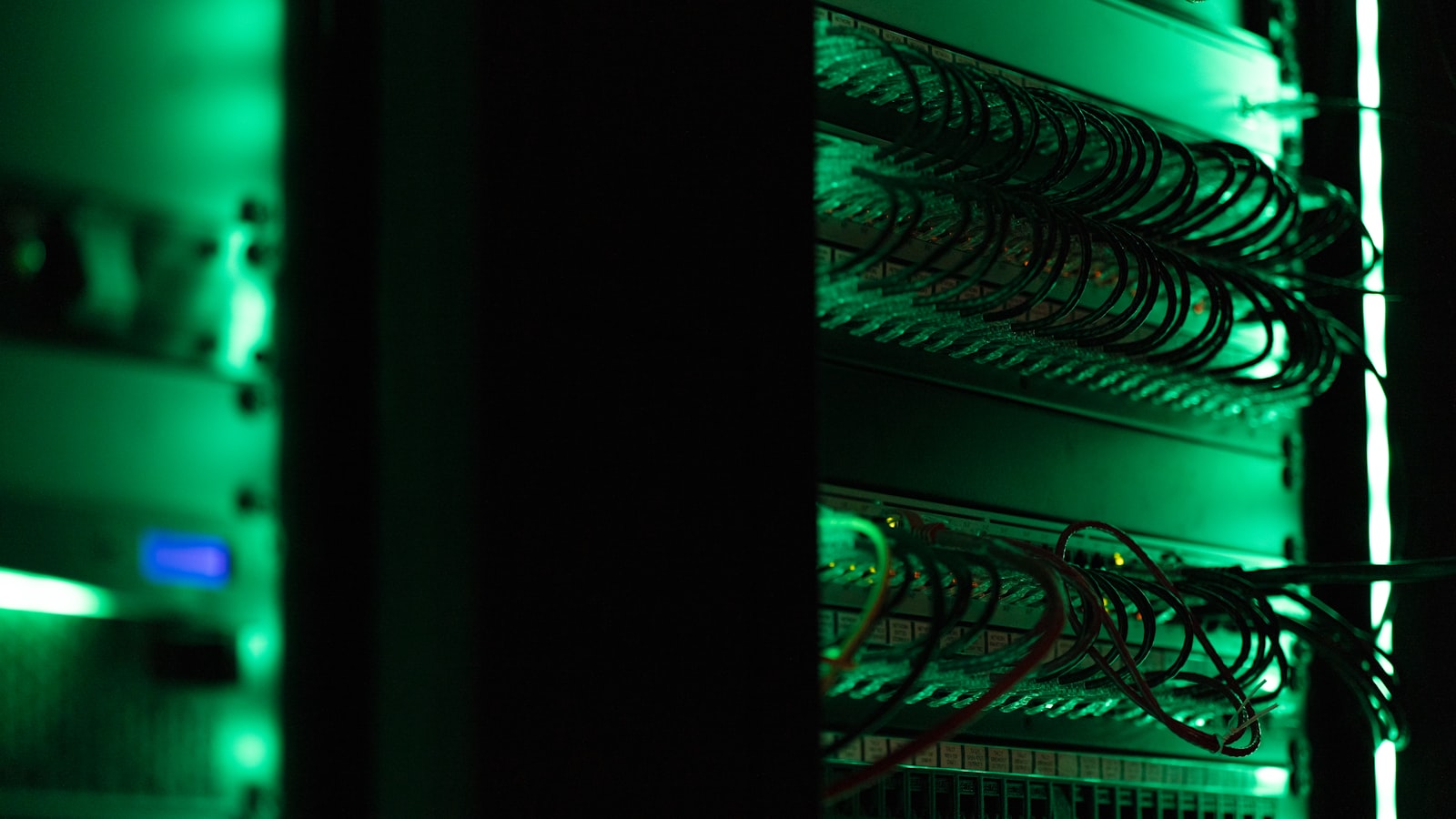 A rack of electronic equipment in a dark room.